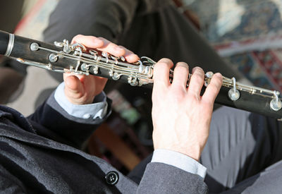 Midsection of man playing guitar