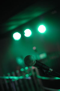 Close-up of microphone in illuminated nightclub