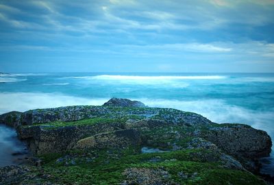 Scenic view of sea against cloudy sky