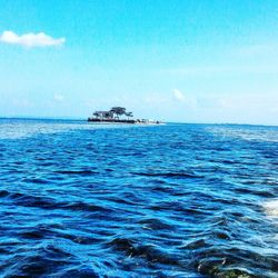 Scenic view of sea against blue sky