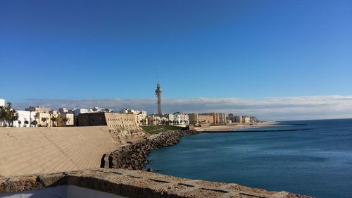 View of beach with city in background