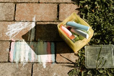 High angle view of colored chalk on pavement 