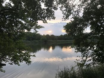 Scenic view of lake against sky at sunset