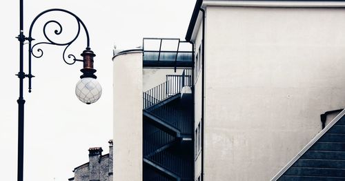 Low angle view of street light against building