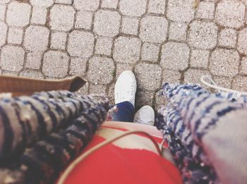 Low section of person standing on tiled floor