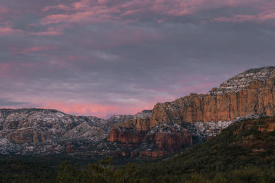 Incredible sunset in sedona arizona in winter with pinks and purples in moody sky.