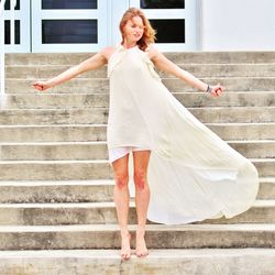 Full length of woman looking away while standing on staircase