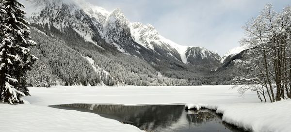 Scenic view of snow covered mountains against sky