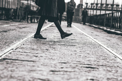 Low section of woman walking on street