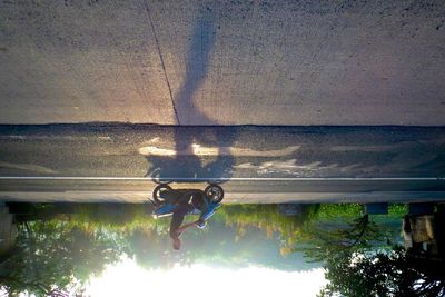 Low section of man in sea against sky