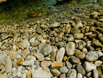 High angle view of pebbles on shore