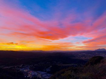 Scenic view of landscape against orange sky