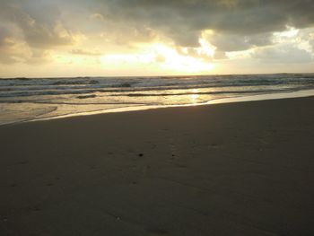 Scenic view of beach against sky during sunset