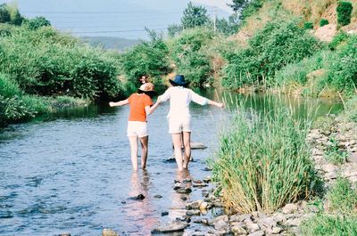 Friends standing in water 