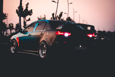 Close-up of traffic on road at sunset