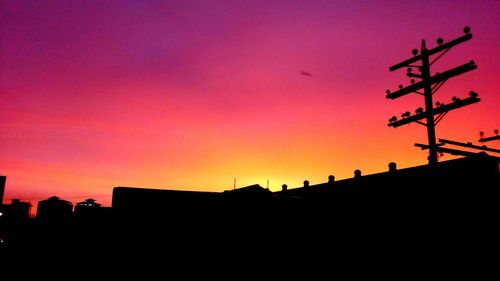 Low angle view of silhouette buildings against sky during sunset