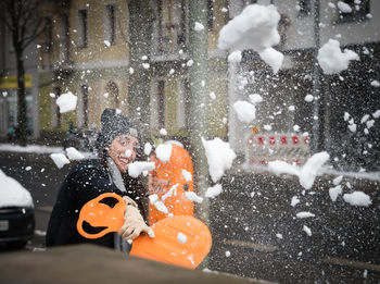 Woman throwing snow during winter