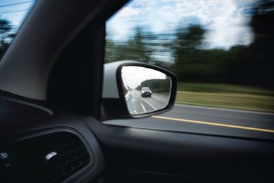 Reflection on side-view mirror of car
