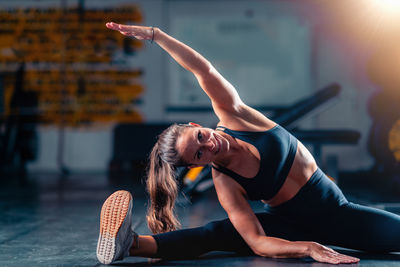 Portrait of young woman exercising in gym