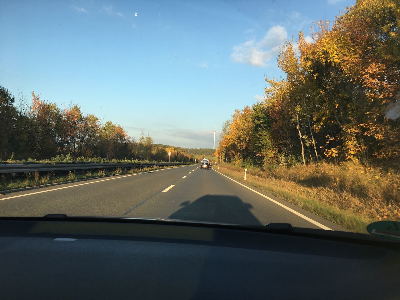 car, transportation, windshield, road, tree, land vehicle, car interior, the way forward, car point of view, mode of transport, vehicle interior, dashboard, clear sky, sky, day, windscreen, no people, nature, outdoors