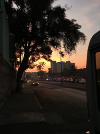 View of city street at sunset