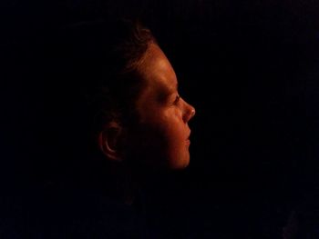 Close-up of young man over black background