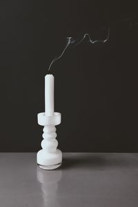 Close-up of smoke emitting from candle against black background