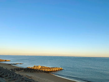 Scenic view of sea against clear blue sky