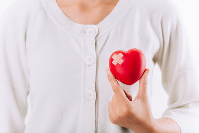 Close-up of woman holding heart shape