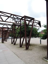 Metallic structure on field against sky