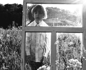 Close-up of boy standing in meadow