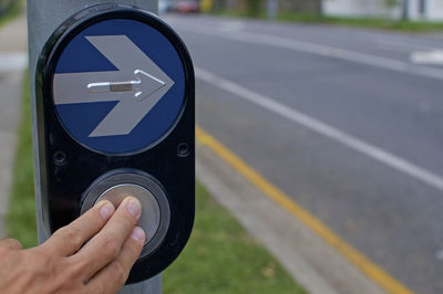 Close-up of hand sign on road