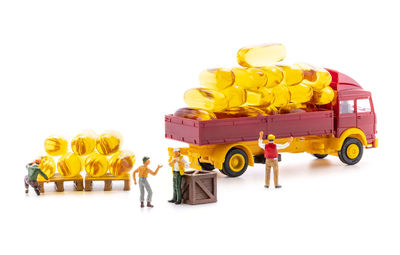 Close-up of yellow toy car against white background