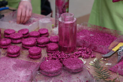 Close-up of hand with ice cream on table