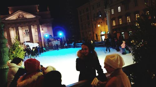 People on street in city at night during winter