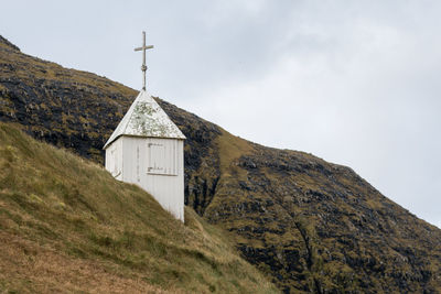 View of cross on mountain against sky