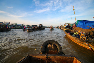 Boats moored on sea against sky