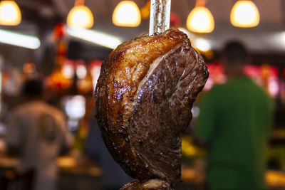 Brazilian style beef ribs barbecue grill on skewers at a churrascaria steakhouse in brazil.