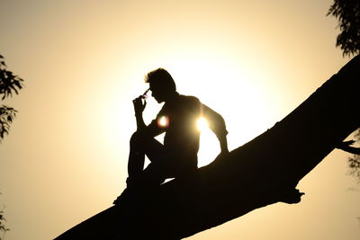 Low angle view of silhouette man against sky during sunset