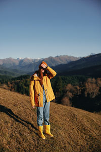 Rear view of woman standing on mountain