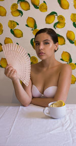 Portrait of young woman holding ice cream