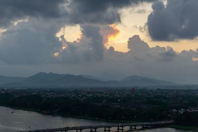 Aerial view of townscape against sky at sunset