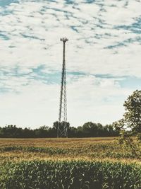 Scenic view of field against cloudy sky