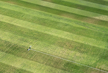 Aerial view of person making yard lines at soccer field