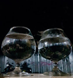 Close-up of glass on table against black background