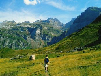 Man hiking on grassy field