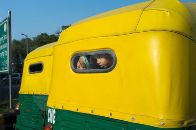 Close-up of yellow car against sky