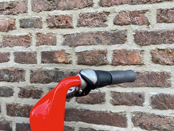 Close-up of fire hydrant against brick wall