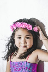 Portrait of cute girl with pink flower