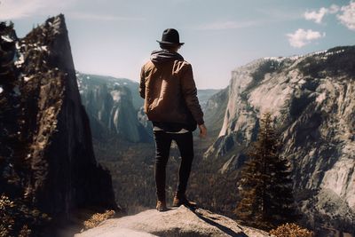 Rear view of man standing on mountain